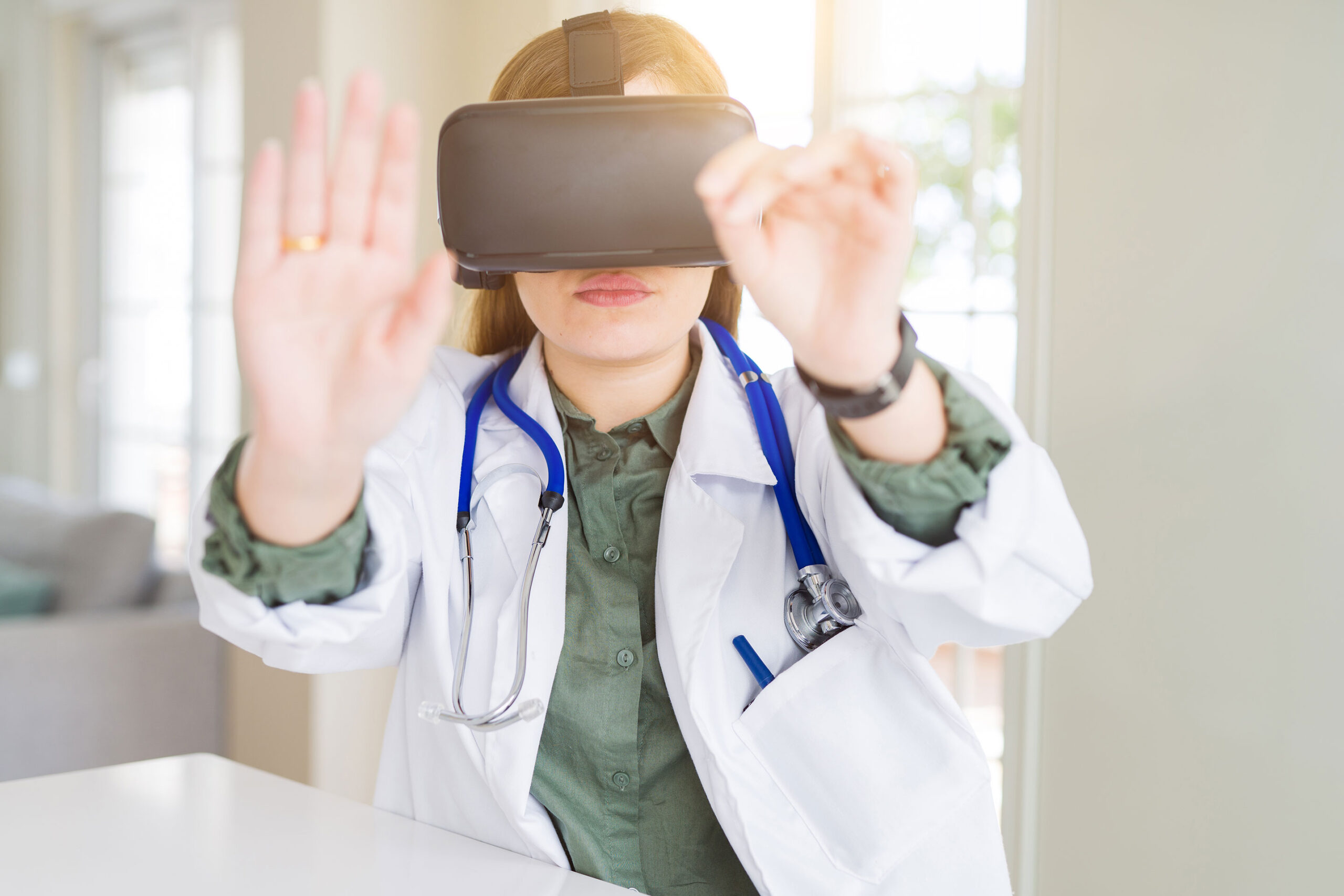 Female doctor looking through virtual reality headset